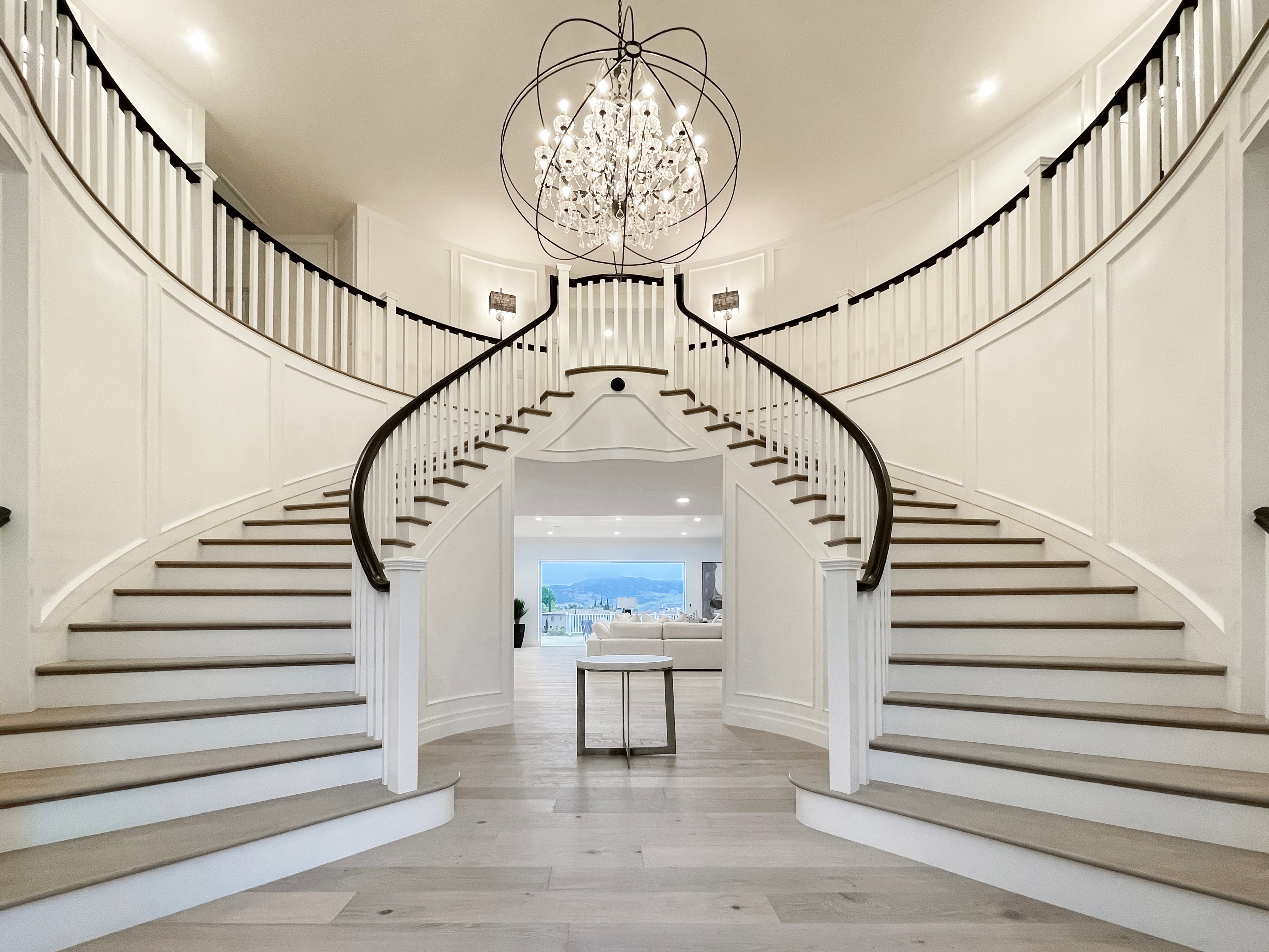 Grand dual staircase foyer with chandelier