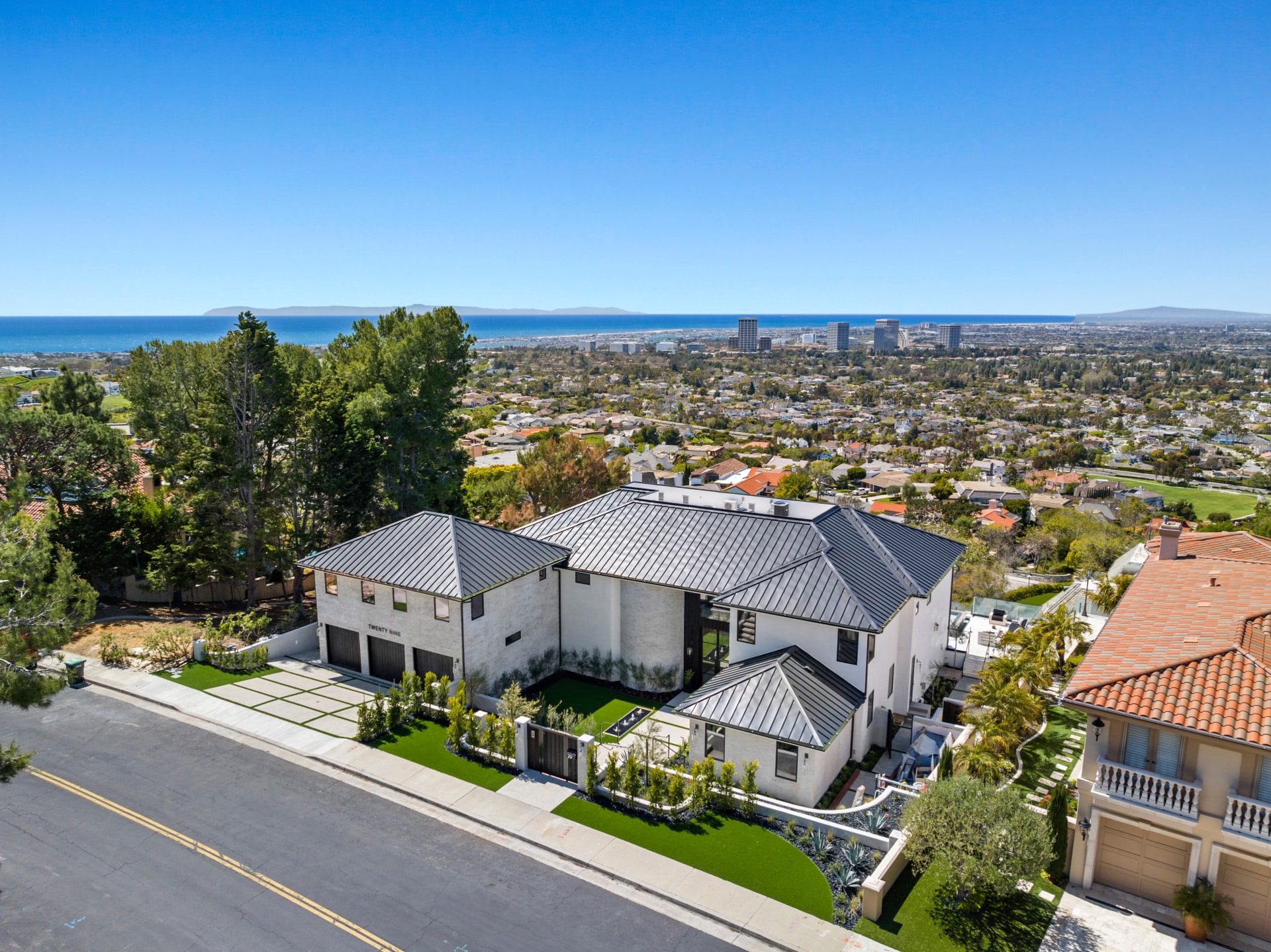 Modern hilltop home overlooking coastal city